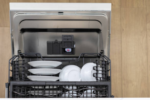 istock Open and loaded dishwasher with dirty crockery 1330866673
