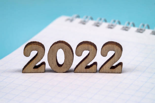 istock Figures 2022 on blue background. Banner 2022 and notepad. 1330868111