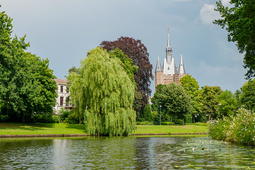 Hanau, Germany – May 13, 2021: Philippsruhe Castle in Hanau, Germany in the evening light. Built between 1700 and 1725. Park and fountain in spring. Dark stormy sky.