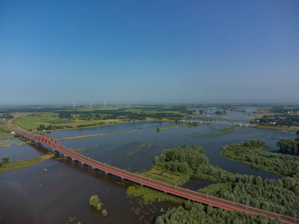 istock Hanzeboog train bridge with high water level on the floodplains 1330869339