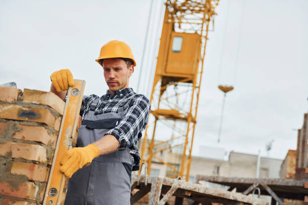 istock With level measuring tool. Construction worker in uniform and safety equipment have job on building 1330871218