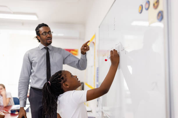istock Primary School Teacher and students In Classroom 1330871309