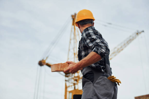 istock Communicates with the crane driver. Construction worker in uniform and safety equipment have job on building 1330872742
