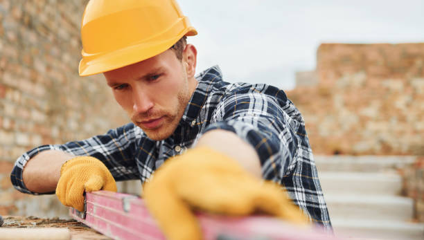 istock With level measuring tool. Construction worker in uniform and safety equipment have job on building 1330874255