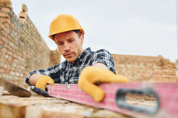 istock With level measuring tool. Construction worker in uniform and safety equipment have job on building 1330874338