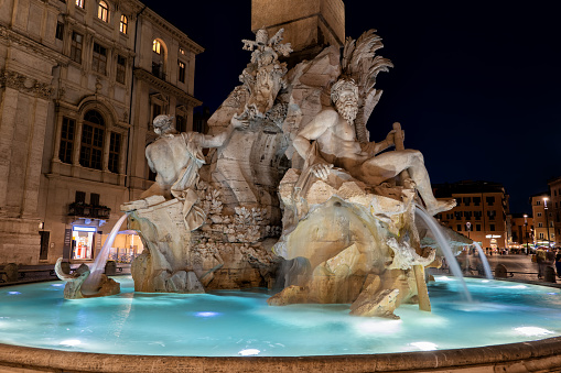 Italy, Rome, Fontana dei Quattro Fiumi (Fountain of the Four Rivers) on Piazza Navona square at night, designed in 1651 by Gian Lorenzo Bernini.