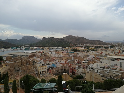 Aerial view of the seaport of Cartagena, Murcia. View of mountains and buildings by the sea and various boats and ships. Spain