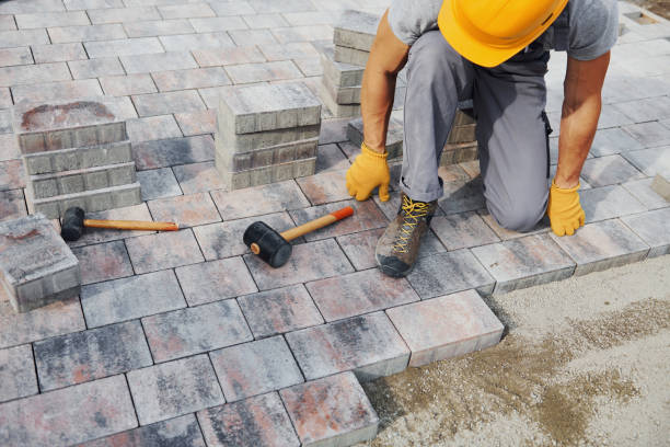 istock Uses a rubber hammer. Male worker in yellow colored uniform have job with pavement 1330876344