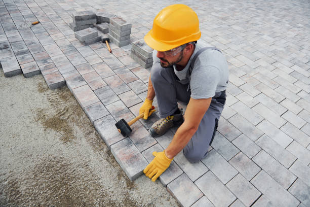 istock Concentrated at work. Man in yellow colored uniform have job with pavement 1330876461