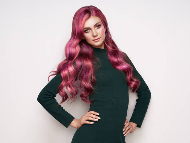 Beautiful woman in knitted dress dress Beautiful woman in knitted dress dress. Brunette girl with long healthy and shiny curly pink hair. Care and beauty. Beautiful model woman with wavy hairstyle. Autumn outfit pink hair stock pictures, royalty-free photos & images