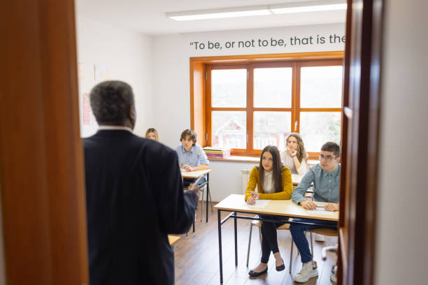istock African - American high school teacher giving a lecture, writing on a white board 1330878766