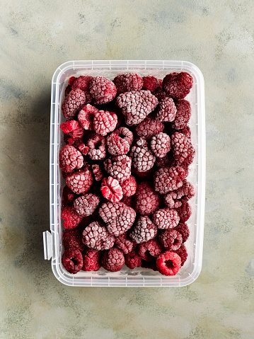 Watermelon, peach, strawberry, lime, cherry and nectarine on grey background. Slices of fresh red fruits and berries. Healthy summer diet with vitamins and antioxidants. Copy space, top view, flat lay.