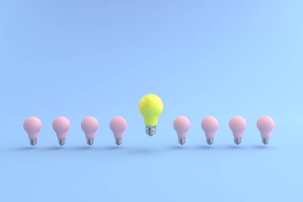 istock 3D rendering of The yellow energy-saving lamp is floating on a pink light bulb placed on a pastel blue floor. and the blue background. concept for new ideas and Outstanding idea, illustration. 1330879595