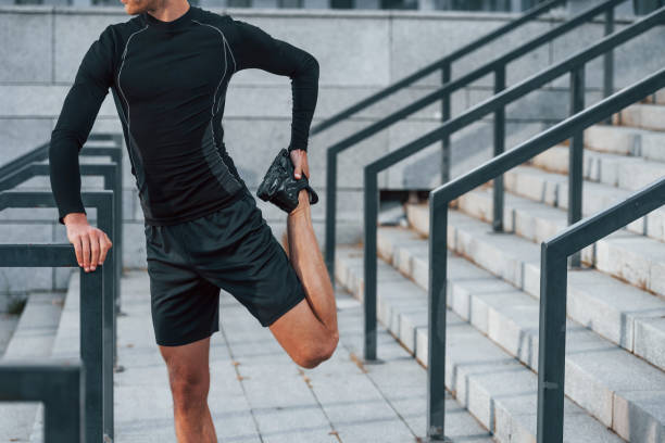 istock Young man in sportive clothes have workout outdoors at daytime 1330879867