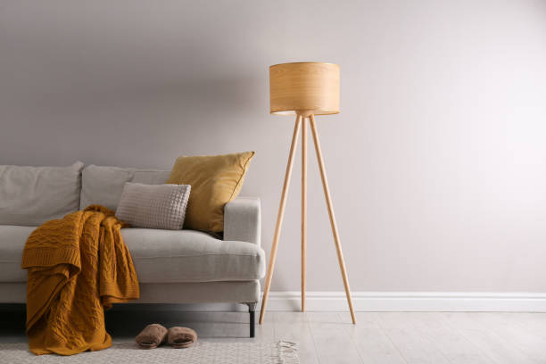 istock Stylish living room interior with comfortable sofa and tripod floor lamp. Space for text 1330881299