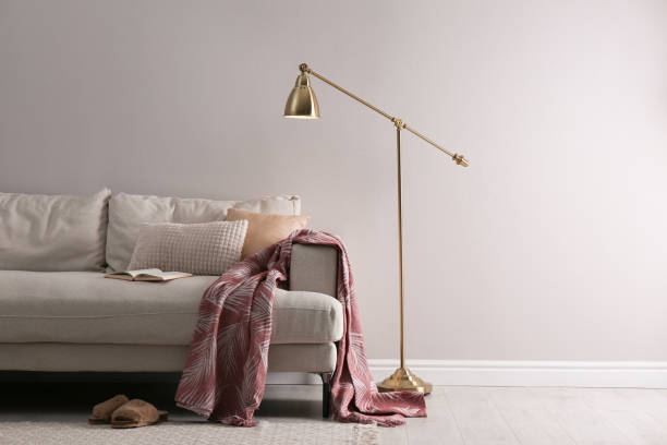 istock Stylish living room interior with comfortable sofa and floor lamp. Space for text 1330881311