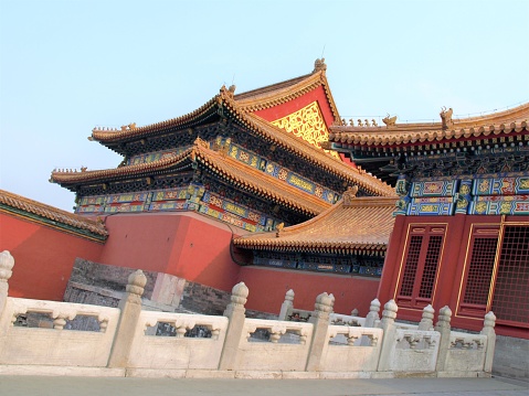 A building in the Forbidden City of Beijing.  The yellow tiles are associated with the emperor, while five animals on the corner of each roof corner indicates a lower status member of the royal family.  This image was taken in the late afternoon in Spring.