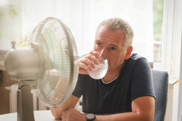 istock Man suffers from heat at home 1330884497