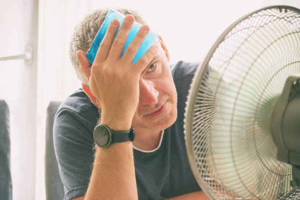 istock Man suffers from heat at home 1330884551