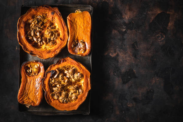 istock Pumpkin and butternut squash roasted oven on dark wooden background 1330884576
