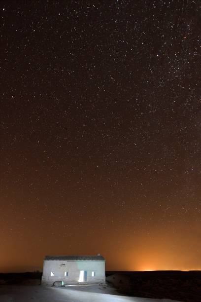 istock Starry sky over an abandoned rural house 1330887770