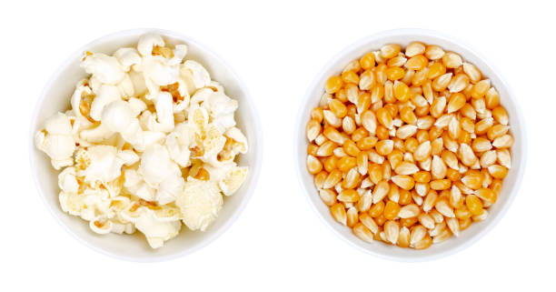 Popped and unpopped popcorn, a popular snack in white bowls