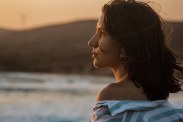 istock Beautiful woman enjoying at sunset 1330890627