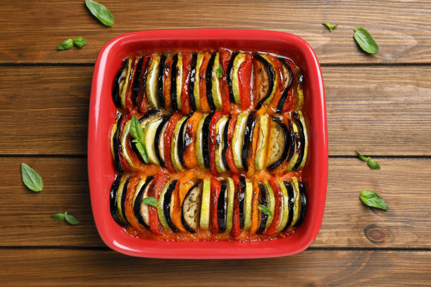 istock Delicious ratatouille in baking dish on wooden table, top view 1330890727