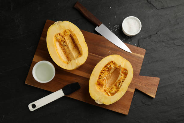 istock Flat lay composition with halves of fresh spaghetti squash on black table. Cooking vegetarian dish 1330890732