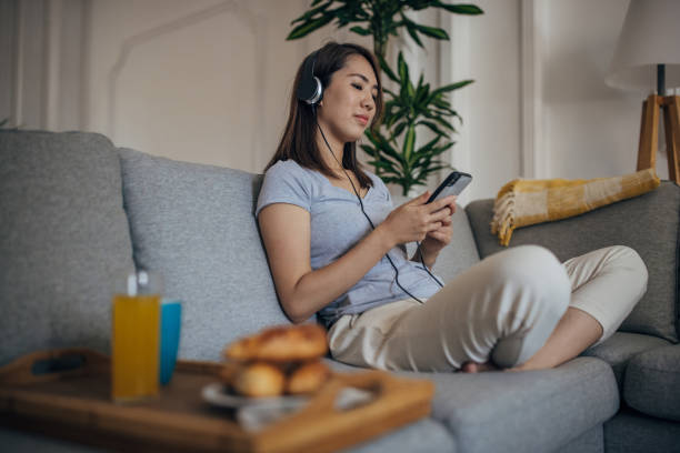 istock Japanese woman relaxing on sofa 1330891090