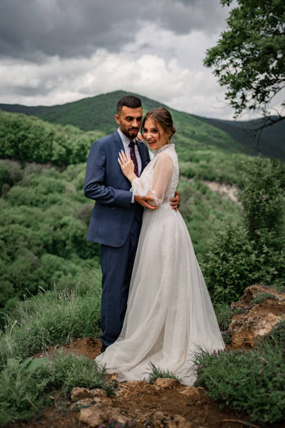 istock a gentle hugging newlyweds in a wedding ceremony in the mountains 1330891143