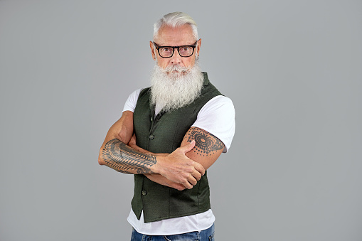 Studio shot of fashionable senior bearded man with eyeglasses. Handsome man portrait.
