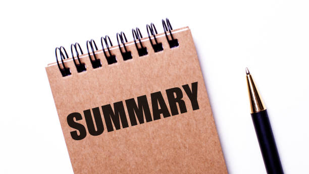 istock SUMMARY written on a brown notebook on a white background near a pen. Close-up. Flatlay 1330893480