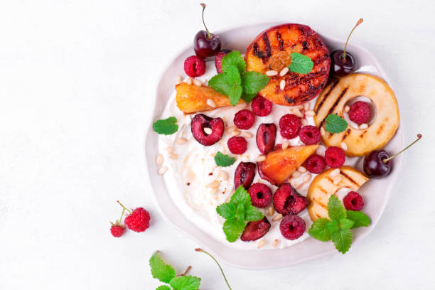 Grilled peach and apple in cottage cheese cream. Fruit dessert