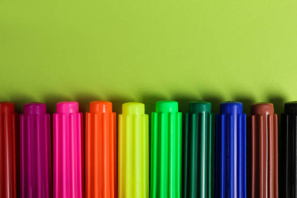 istock Set of felt tip pens on light green background, flat lay 1330894476