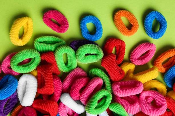istock Different colorful hair ties on light green background, flat lay 1330894565