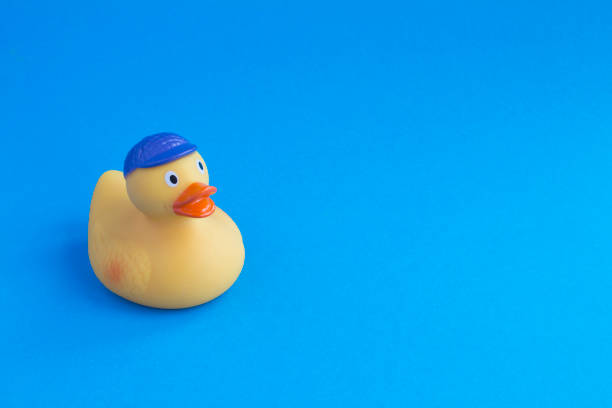 istock Yellow toy duckling for bathing on the blue  background. Copy space. Close-up. 1330895363