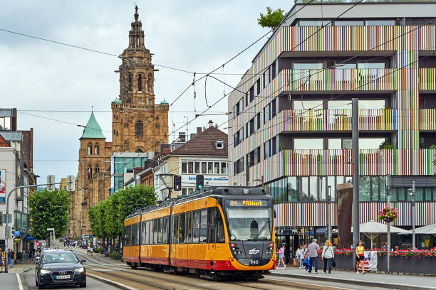 Heilbronnn Heilbronn, Germany - July 17, 2021: Pedestrians and traffic in the Kaiserstraße in Heilbronn. a yellow tram in the foreground. the steeple of Kilians Cathedral in the background. heilbronn stock pictures, royalty-free photos & images