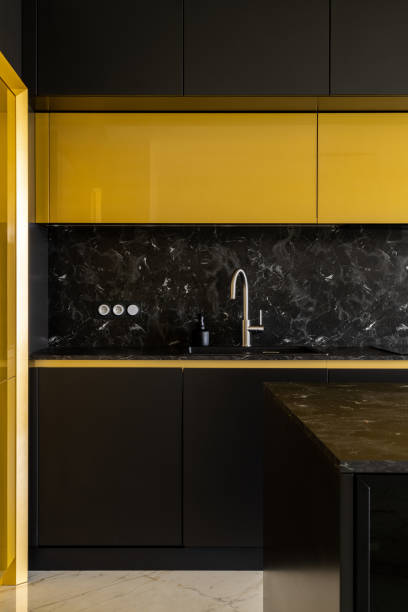 istock Stylish kitchen in black and gold 1330895832