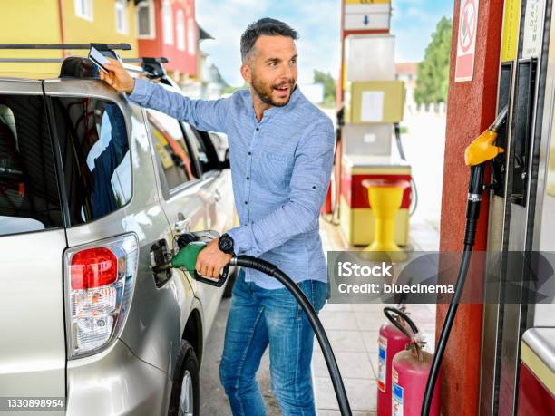 Man Refuel The Car Stock Photo - Download Image Now - Refueling, Fuel Pump, Gasoline