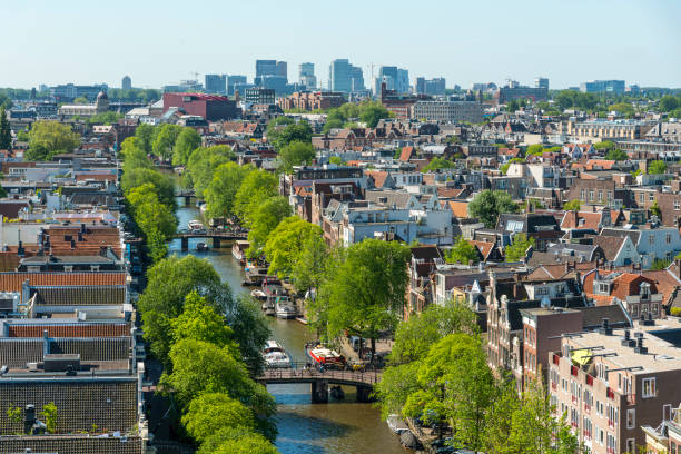 Panorama Amsterdam city view from Westerkerk, Holland, Netherlands. Roofs and facades of Amsterdam and the Prinsengracht. City view to the west, and north. to the Anne Frank house. from the bell tower of the church Westerkerk, Holland, Netherlands. jordaan amsterdam stock pictures, royalty-free photos & images