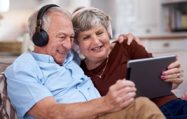 istock Shot of an elderly couple using a digital tablet on the sofa at home 1330903829