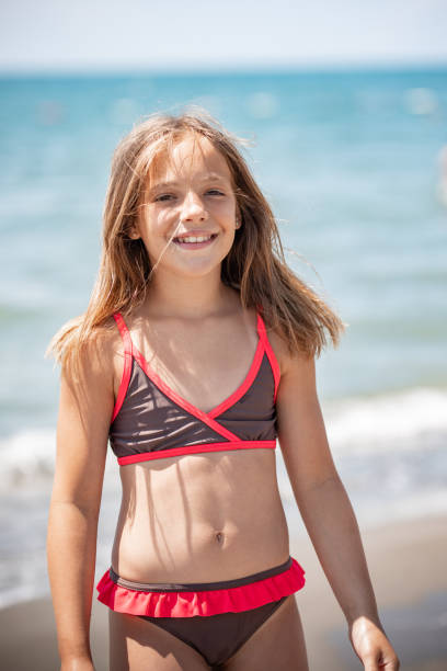Cute Girl at the beach looking at camera