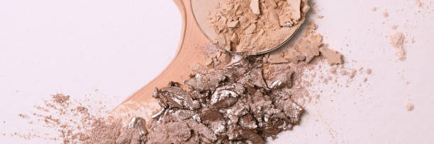 istock Crashed beige face finishing and liquid powder and crashed eyeshadow texture. Macro texture of make-up on beige background 1330906022