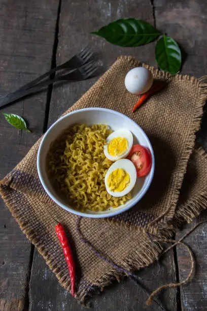 Instant maggi masala egg ramen noodles in a bowl. Top view.