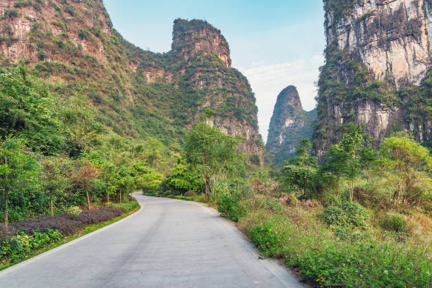 Road between the karst hills near Li River. Road between the karst hills near Li River. China. guilin hills stock pictures, royalty-free photos & images