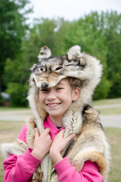 istock Girl wearing wolf pelt over his head 1330907103