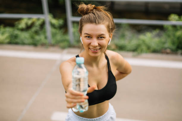 istock young athletic girl in park during training with water bottle 1330907568