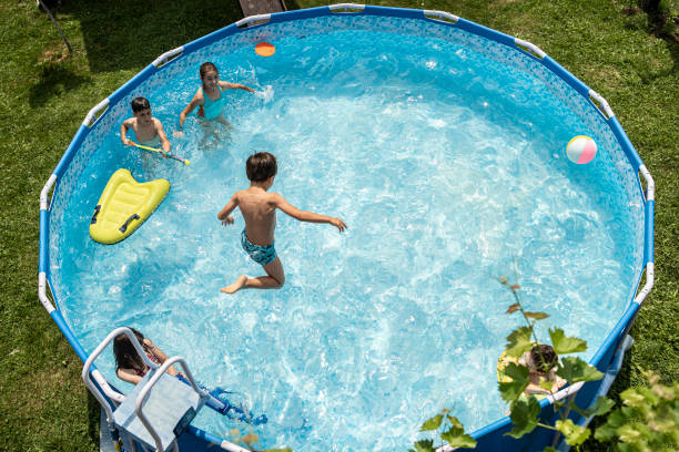 istock High view of a boy leaping into a sparkling swimming pool 1330910610