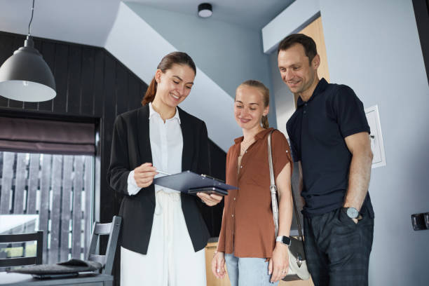 istock Female Real Estate Agent with Clients 1330910900